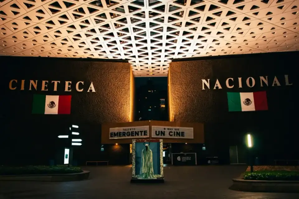 Cineteca Nacional in Mexico City at night, with Mexican flags