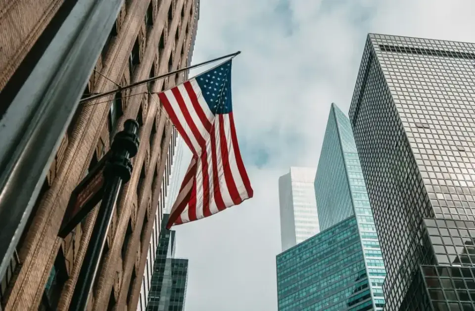 United States flag on a brick building among downtown skyscrapers